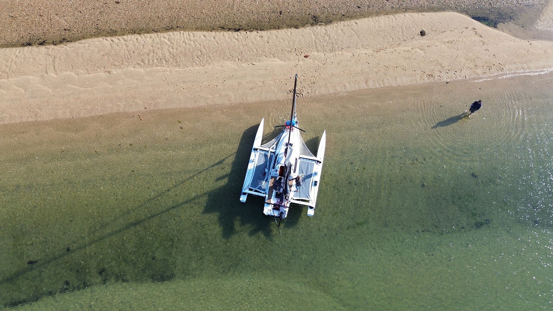 Aerial view of Tricat 6.90 close in to a beach